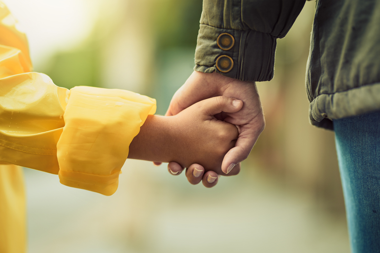 girl and boy holding hands in rain