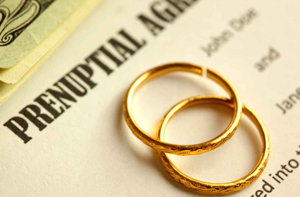 closeup image of prenuptial form and wedding rings