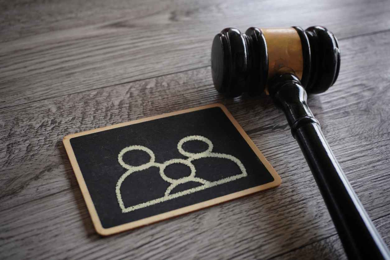 Closeup image judge gavel and chalkboard with family icon. Guardianship, family law concept.